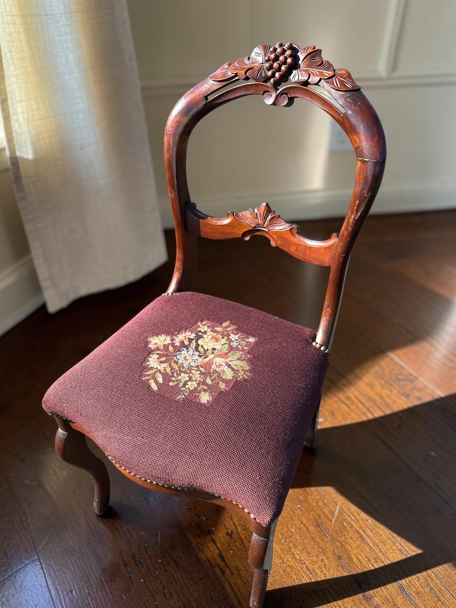 Victorian Carved Balloon-back Chair w/ Burgundy Floral Needlepoint Seat: GET A SHIPPING QUOTE BEFORE YOU BID. . Victorian Carved Balloon-back Chair w/ Burgundy Floral Needlepoint Seat. Deeply carved fruit motif. 35”tall x 18 1/2”wide x 23”front-to-back.