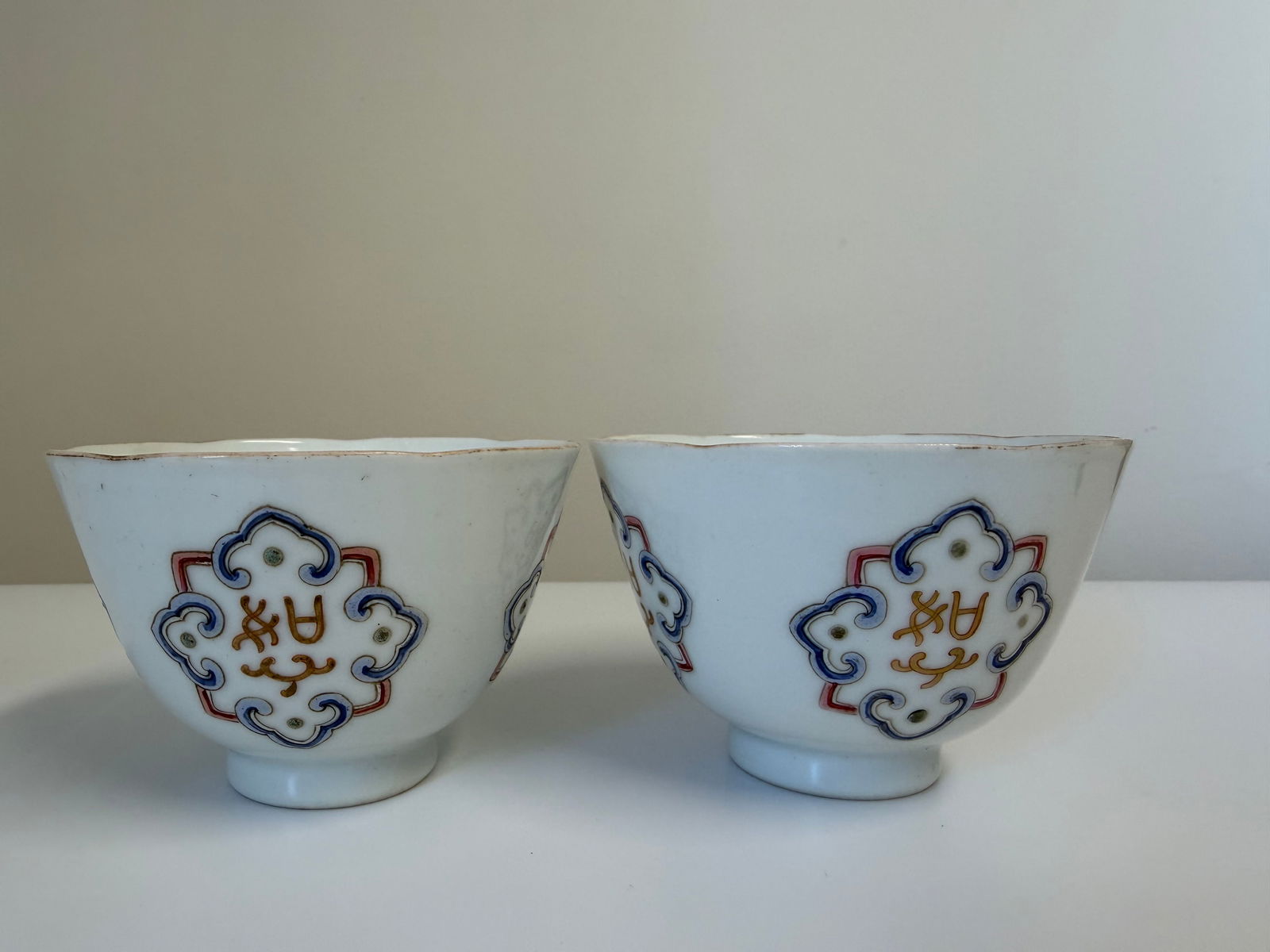 Pair of Chinese enameled famille rose porcelain cups China characters mark: Dimension: inch / cm , please note Due to manual measurement, dimensions may vary. Condition: Good used condition, please note buyers are obligated to come to the site to inspect the condition and