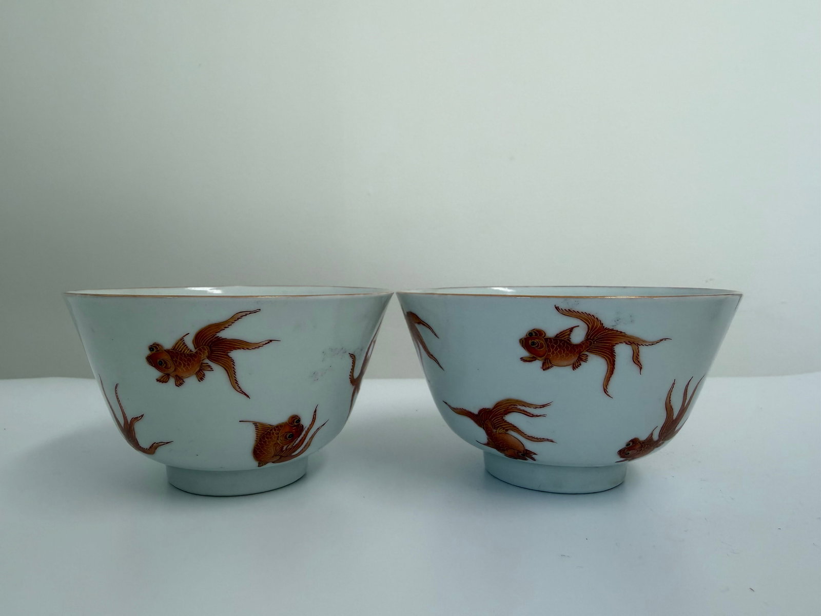 Pair of Chinese Enameled famille rose gilded fish porcelain China bowls: Dimension: width 3.9 inches/ 9.9 cm, please note Due to manual measurement, dimensions may vary. Condition: Good used condition, please note buyers are obligated to come to the site to inspect the con