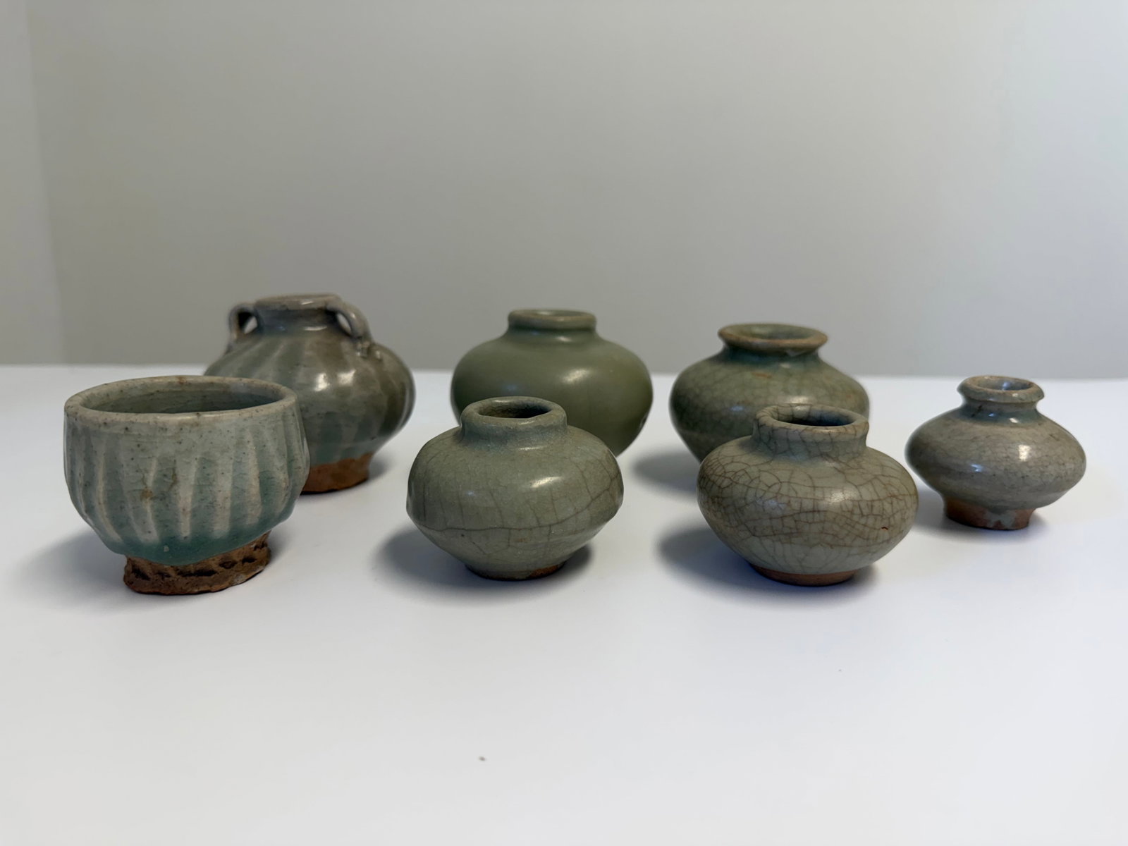 Set of 7 Chinese green glazed porcelain pots: Dimension: 2-3.6 inches , please note Due to manual measurement, dimensions may vary. Condition: Good used condition, please note buyers are obligated to come to the site to inspect the condition and 