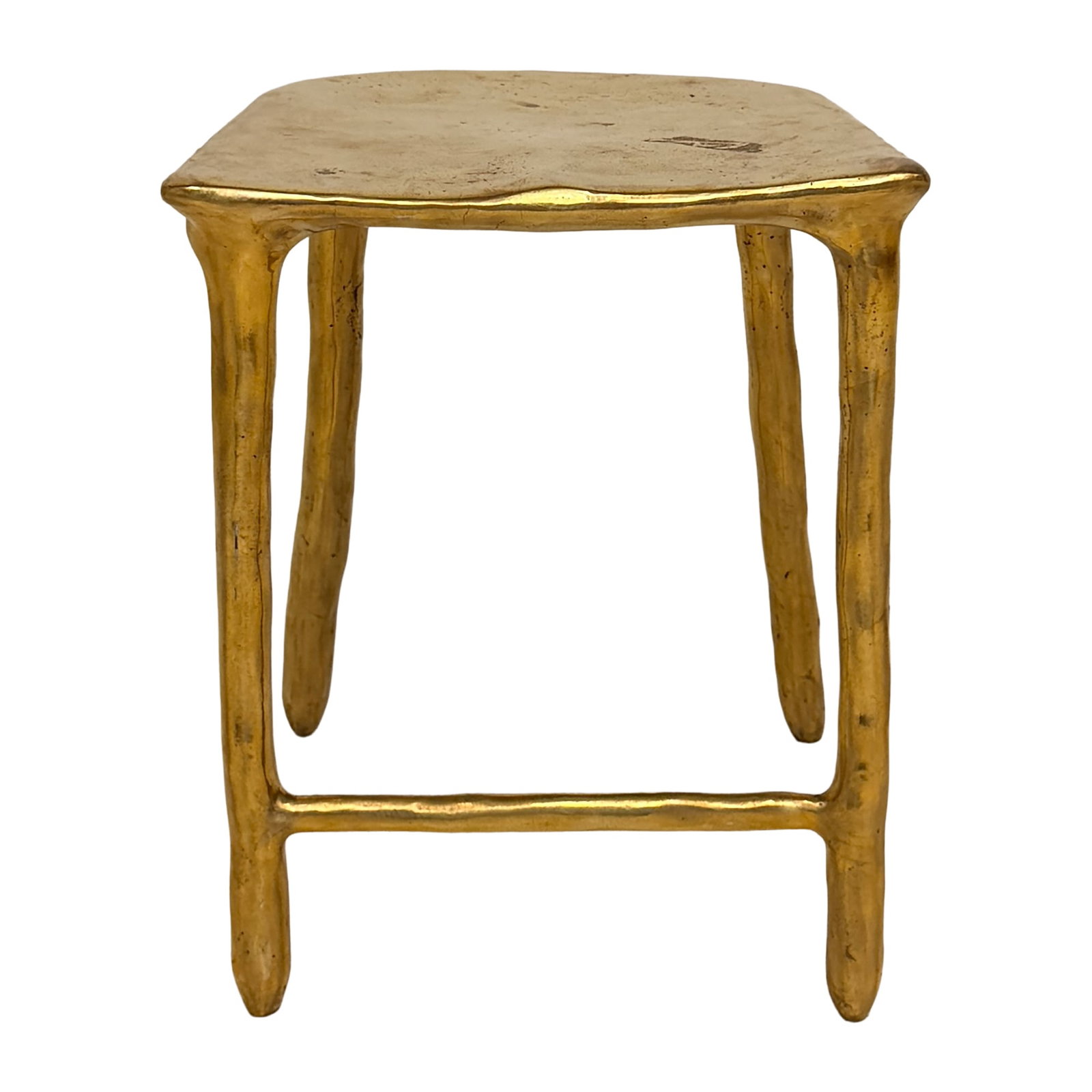 Sculptural Brass Accent Stool: Sculptural brass accent stool featuring a softly rectangular top supported by slender, organically shaped tapered legs and connecting stretchers. The warm polished metallic finish and subtly irregular