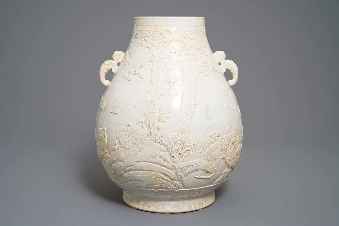 A Chinese monochrome cream-glazed relief-decorated hu vase, Qianlong mark, 20th C. (1 of 6)