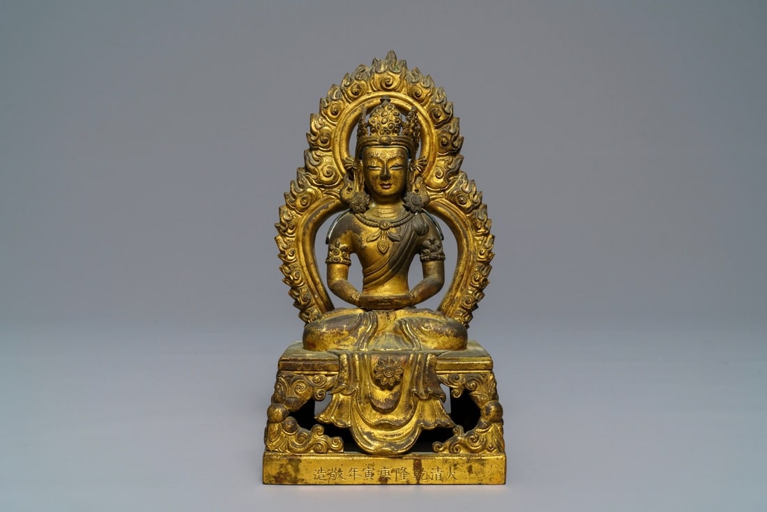 A Sino-Tibetan gilt bronze figure of Amitayus, dated 1770, Qianlong: A Sino-Tibetan gilt bronze figure of Amitayus, dated 1770, Qianlong ----- H.: 21,3 cm Provenance: The private collection of a deceased Belgian antiques dealer.