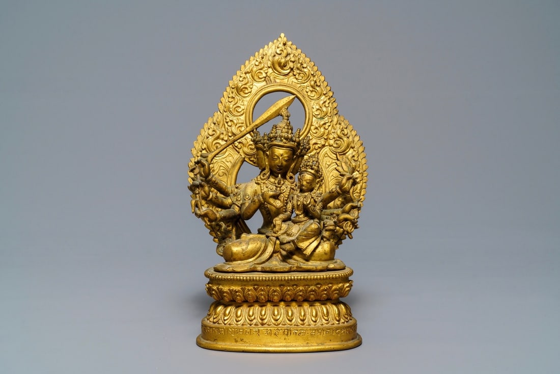 A Tibetan inscribed gilt bronze group of Manjusri and Prajnaparamita, 17/18th C.: A Tibetan inscribed gilt bronze group of Manjusri and Prajnaparamita, 17/18th C. ----- H.: 22,2 cm Provenance: The private collection of a deceased Belgian antiques dealer.