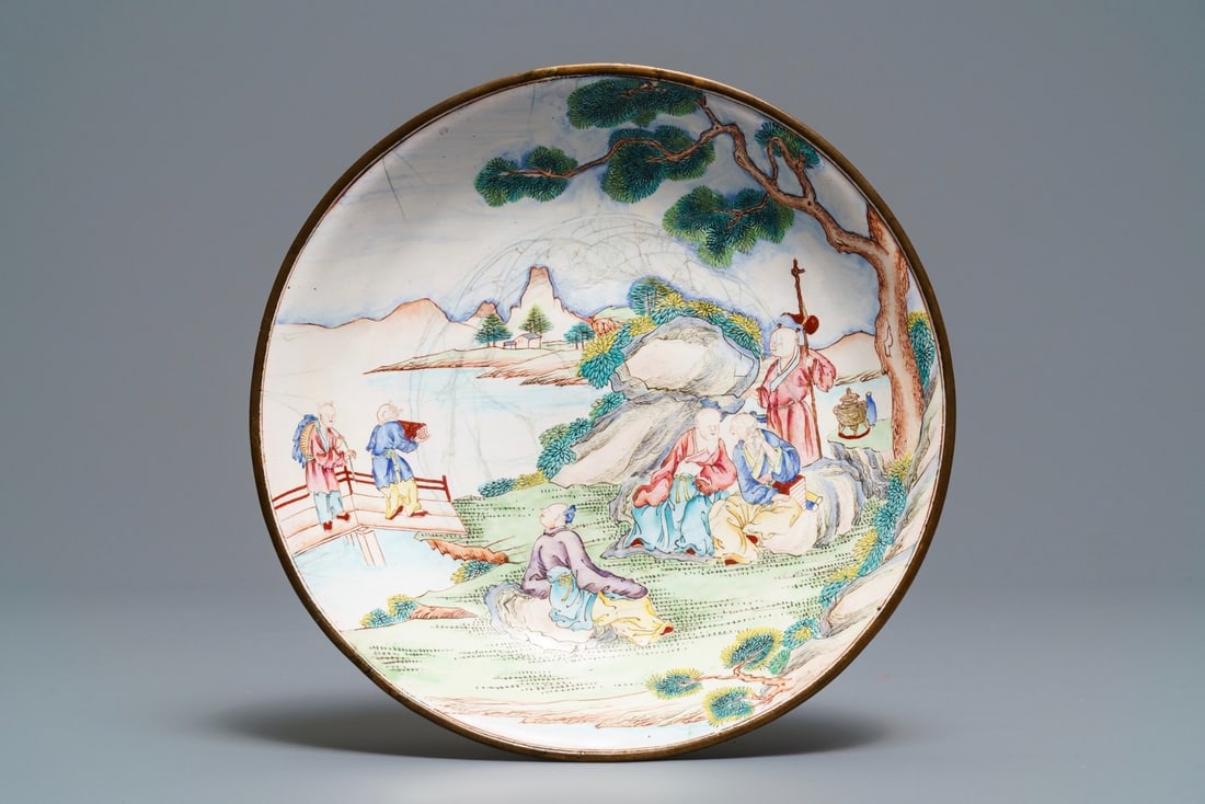 A Chinese Canton enamel dish with figures in a garden, Qianlong mark and of the period (1 of 2)