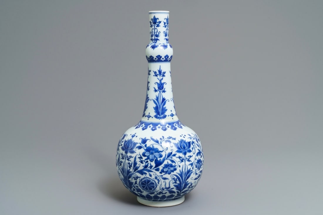 A Chinese blue and white bottle vase with floral design: A Chinese blue and white bottle vase with floral design, Transitional period ----- H.: 42 cm Provenance: With a label on the base for Vanderven Antiquairs, The Netherlands.