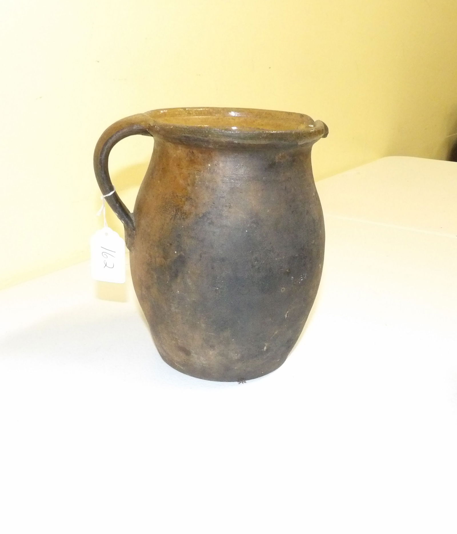 Tall Clay Pottery Pitcher: 8" Tall Clay Pottery Pitcher. All measurements approximate. Please see photos for condition and details. Selling as is from 04281.