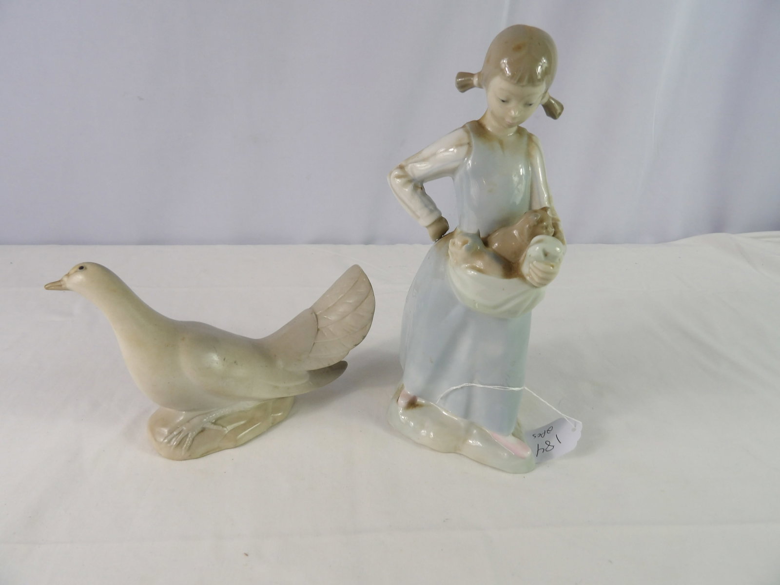 2 Pcs.- Spanish Porcelain Figurines 1 Bird, 1 Girl with Kittens: 2 Pcs.-Spanish Porcelain Firgurines, 1 Bird and 1 Girl with Kittens. All measurements approximate. Please see photos for condition and details. Selling as is from 04281.