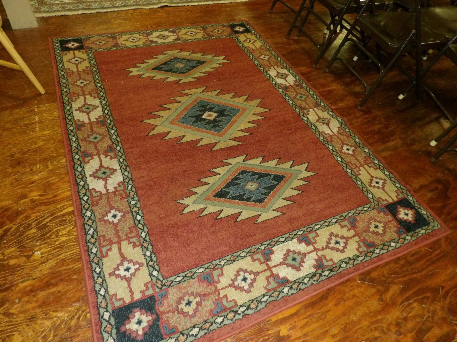 Woven rug with southwest design: Woven rug with southwest design. 5' by 7'. All measurements approximate. Please see photos for condition and details. Selling as is from 04281.