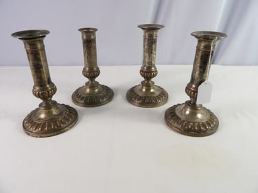 Four 6 1/2" early candle sticks