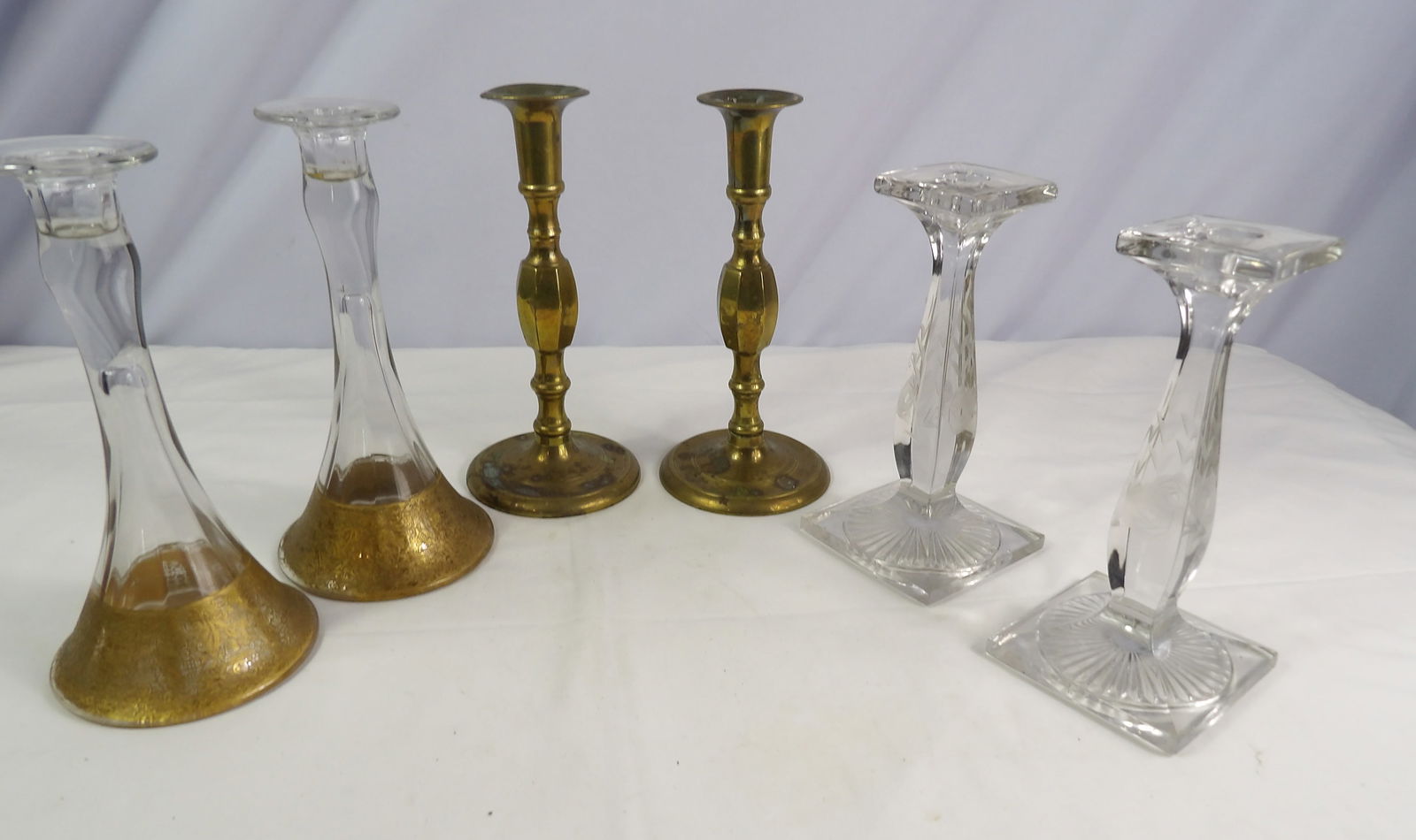 3 Sets of Candlesticks: 3 Sets of Candlesticks, 2 sets Glass and 1 set Brass. All measurements approximate. See photos for condition and details. Selling as is from 04281.