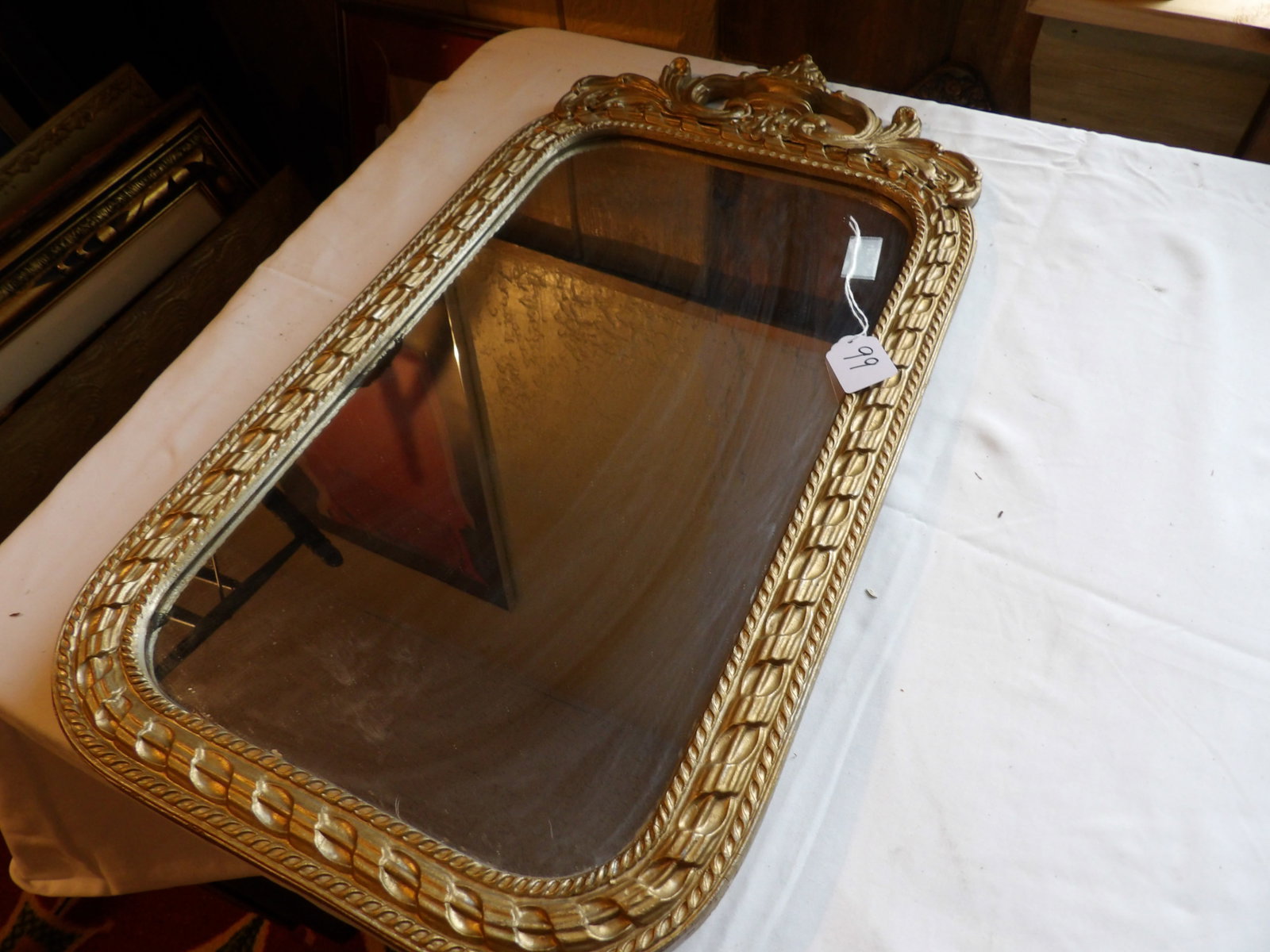 Gilded Framed Mirror: 12" x 23" Gilded Framed Mirror. All measurements approximate. See photos for condition and details. Selling as is from 04281.