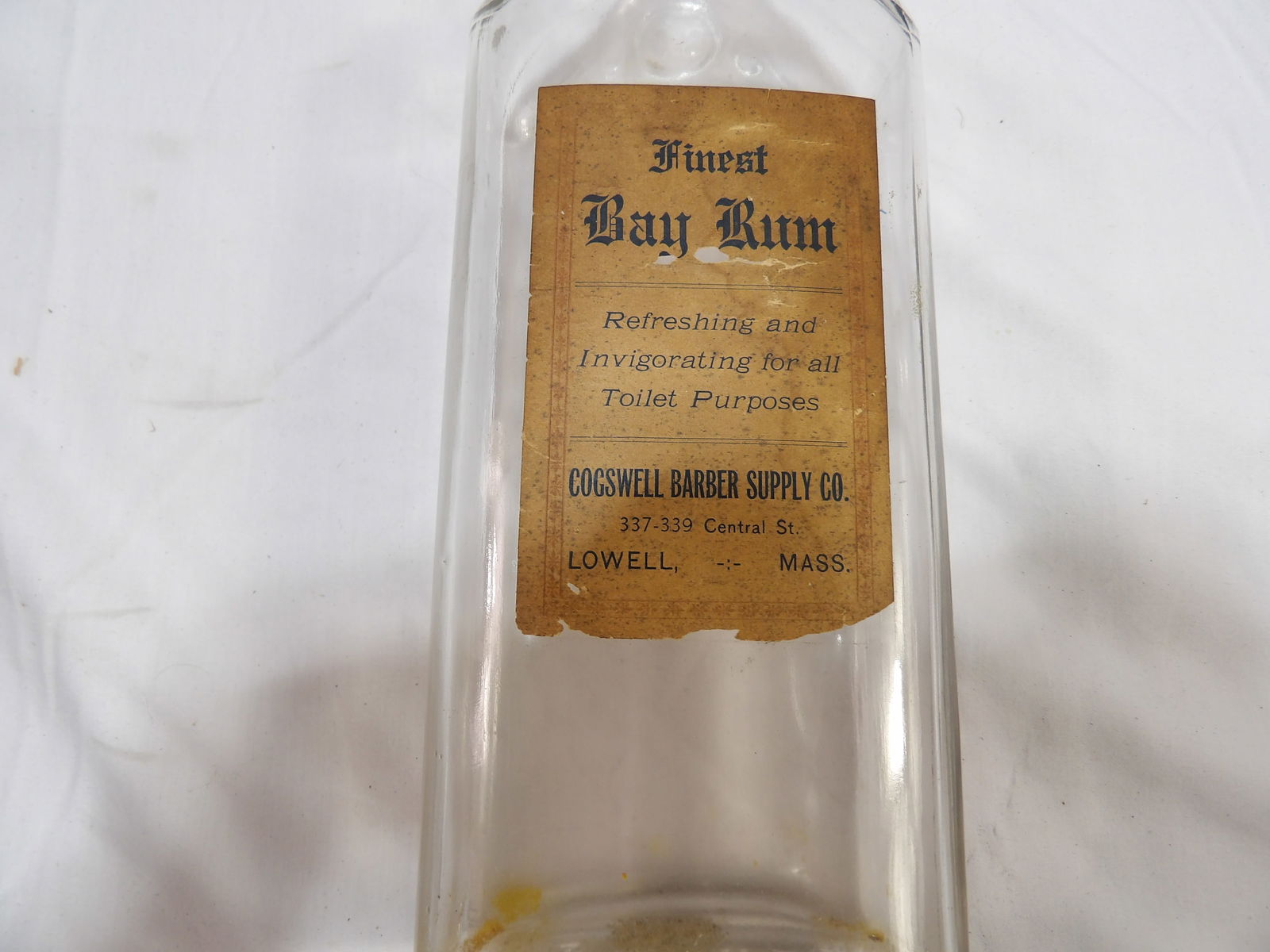 Bay Rum Bottle: 11" Bay Rum Bottle. Cogswell Barber Supply. All measurements are approximate. Please see photos for condition and details. Selling as is from 04281.