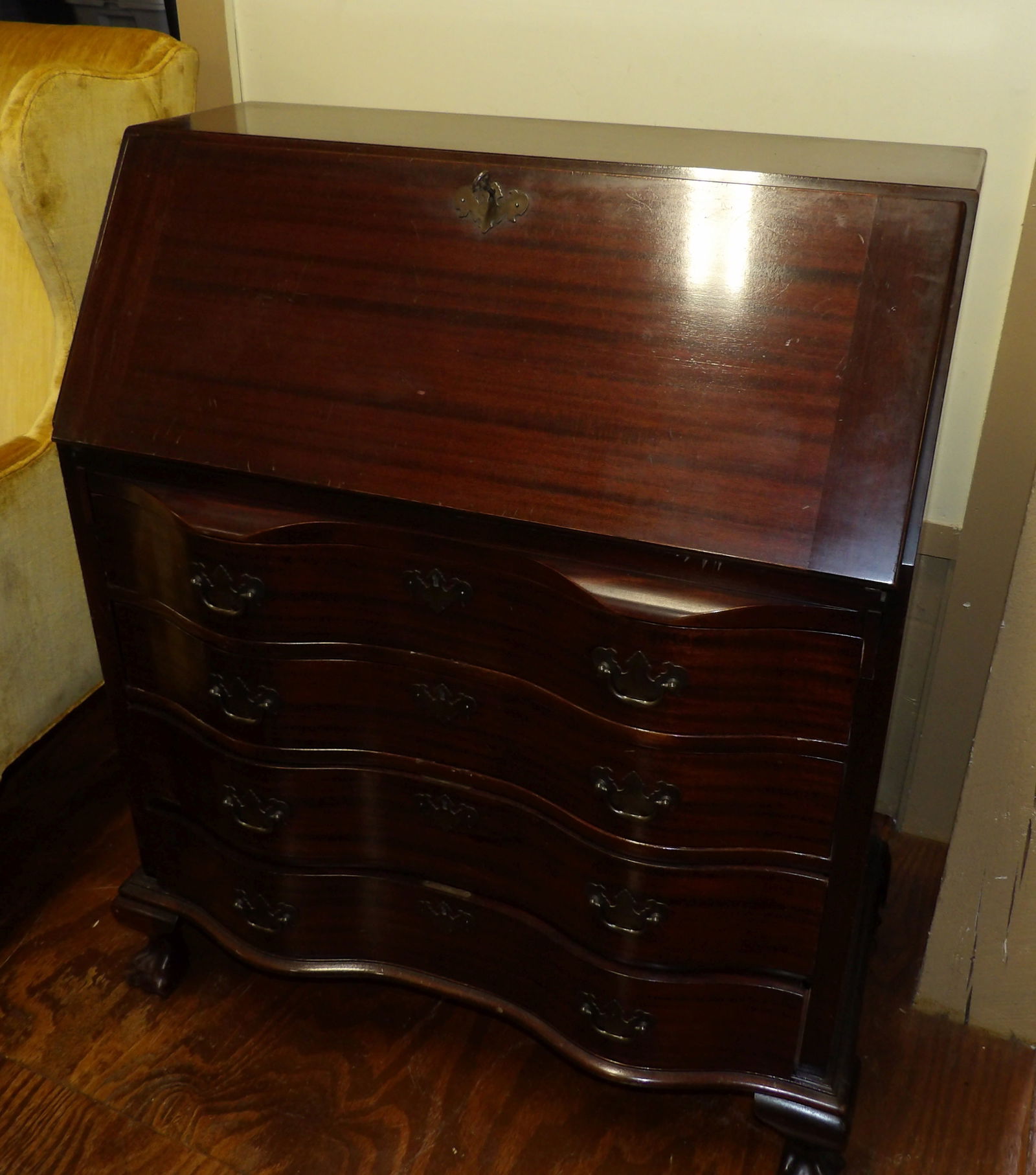 MahoganySerpentine Desk: Red Mahogany Serpentine Desk with Claw Feet by Maddox Furniture. All measurements are approximate. Please see photos for condition and details. Selling as is from 04281.