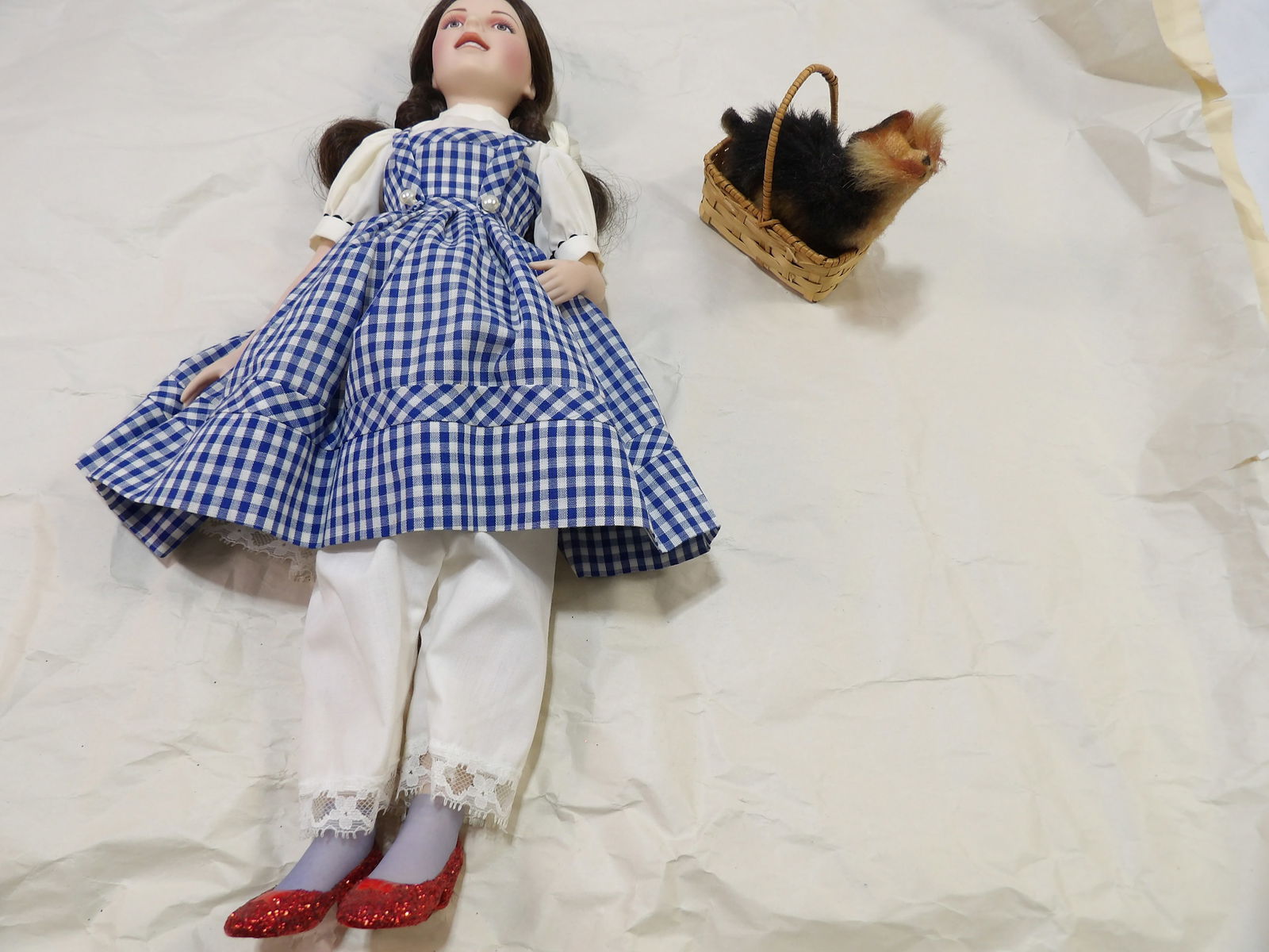 Porcelain Dorothy and Toto Doll: Porcelain Dorothy and Toto Doll, 18" Inch. All measurements are approximate. Please see photos for condition and details. Selling as is from 04281.