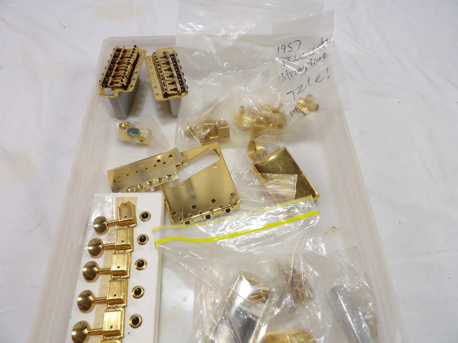 Fender Gold Colored Parts Lot: Fender Gold Colored Parts Lot. Some from 1957 Telecaster. All measurements are approximate. Please see photos for condition and details. Selling as is from 04281.
