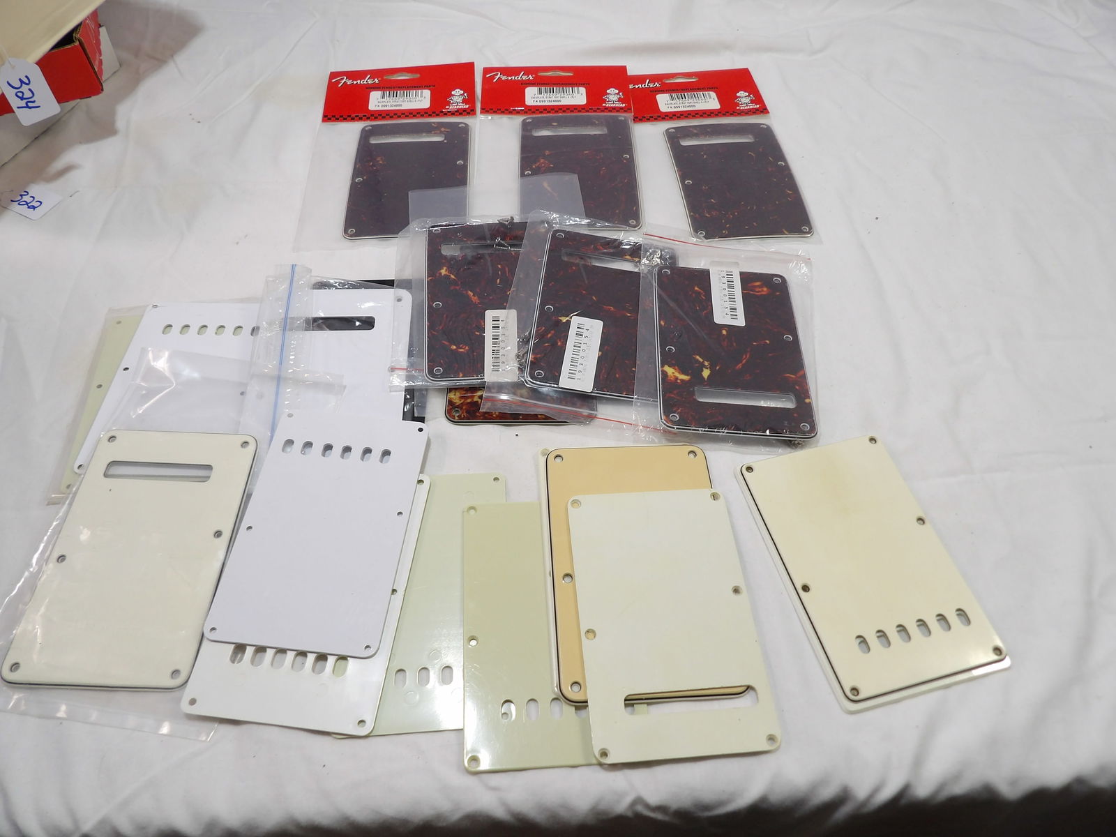 Large Lot of Fender Back Plastes: Large Lot of Fender Back Plates, New and Used. All measurements are approximate. Please see photos for condition and details. Selling as is from 04281.