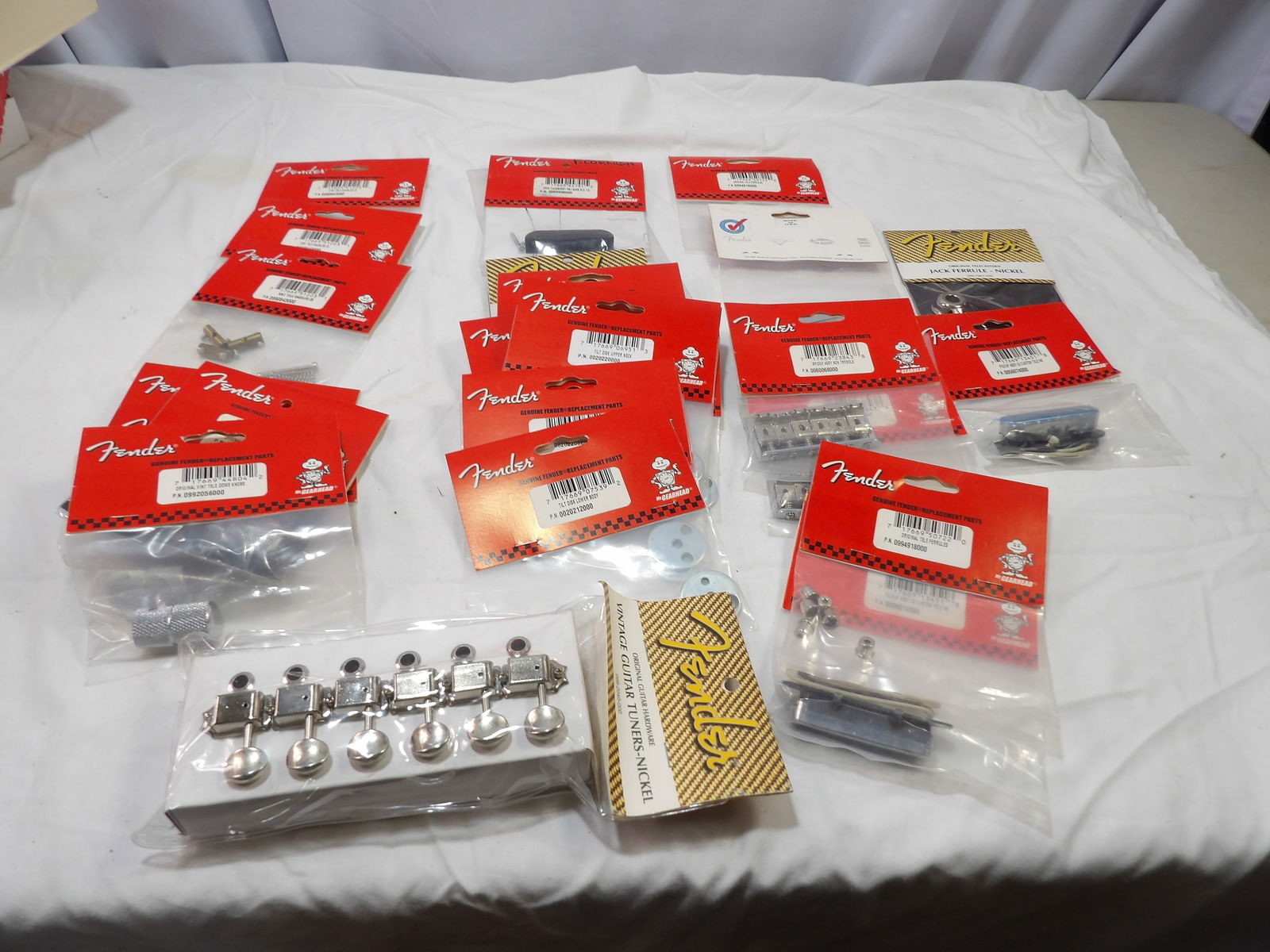 Large Lot of New Fender Parts: Large Lot of New Fender Parts, Tele Ferrules, Bridge Assemblys, Tilt Disks, Dome Knobs, Tele Saddles. All measurements are approximate. Please see photos for condition and details. Selling as is from