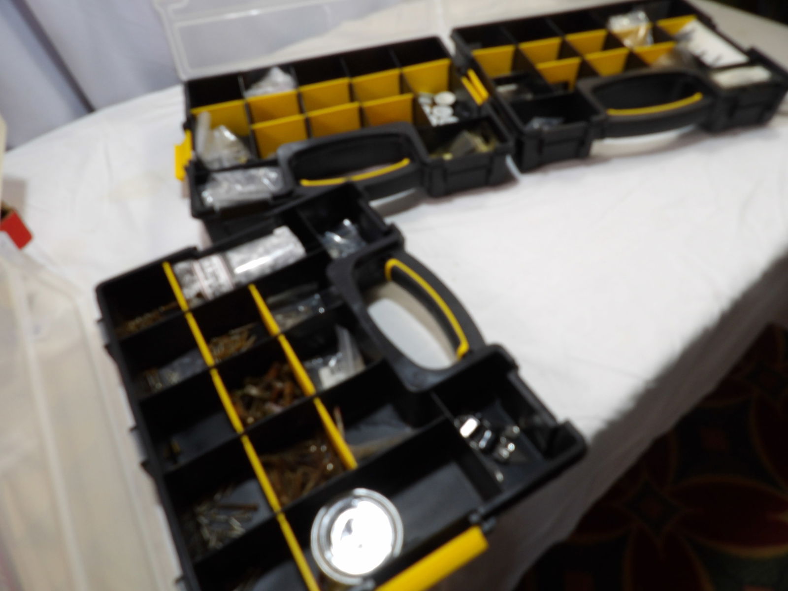 Miscellaneous Fender Parts Lot: 3 Parts Containers Full of Assorted Fender Screws, Springs, Knobs, Etc. All measurements are approximate. Please see photos for condition and details. Selling as is from 04281.