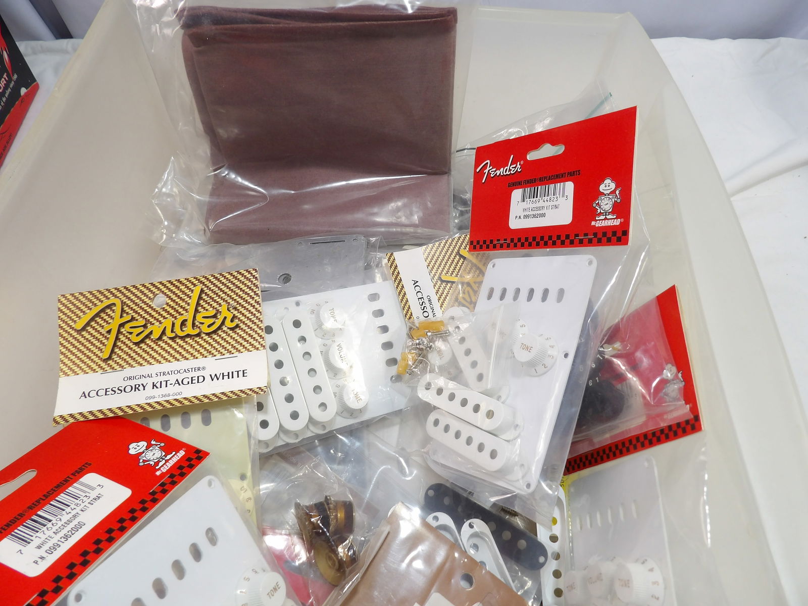 Large Fender Parts Lot: Large Fender Parts Lot, Pick Ups, Covers, Knobs, Etc. All measurements are approximate. Please see photos for condition and details. Selling as is from 04281.