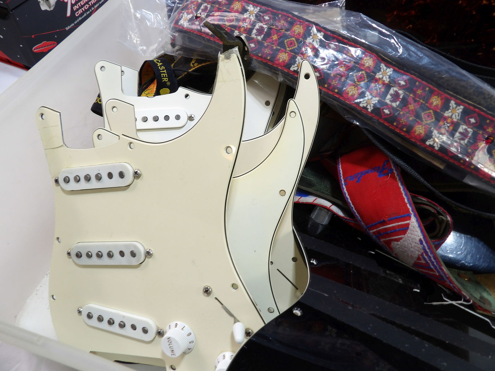Lot of Fender Pick Guards: Lot of Fender Pick Guards with Electronics and a few Guitar Straps. All measurements are approximate. Please see photos for condition and details. Selling as is from 04281.