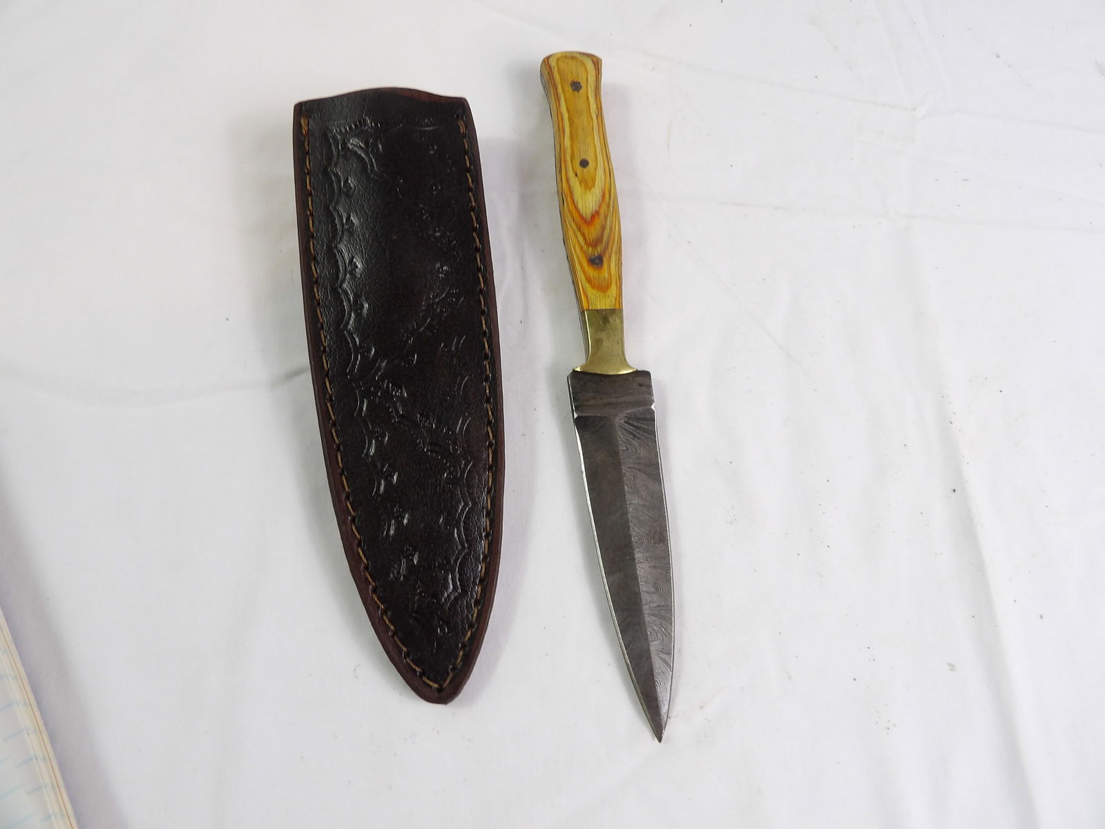 MHS Cutlery: MHS Cutlery, Hand Forged Damascus Steel Dagger with Sheath. All measurements approximate. Please see photos for condition and details. Selling as is from 04281.