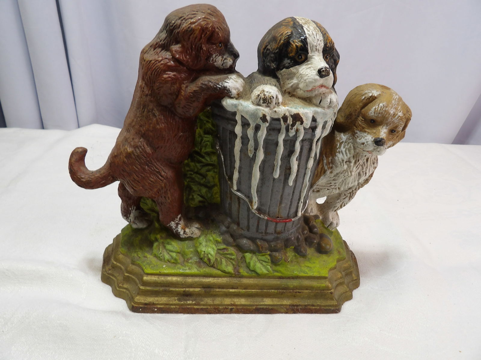 Cast Iron Doorstop: Vintage Cast Iron Doorstop, "3 Puppies around a Bucket". All measurements approximate. Please see photos for condition and details. Selling as is from 04281.