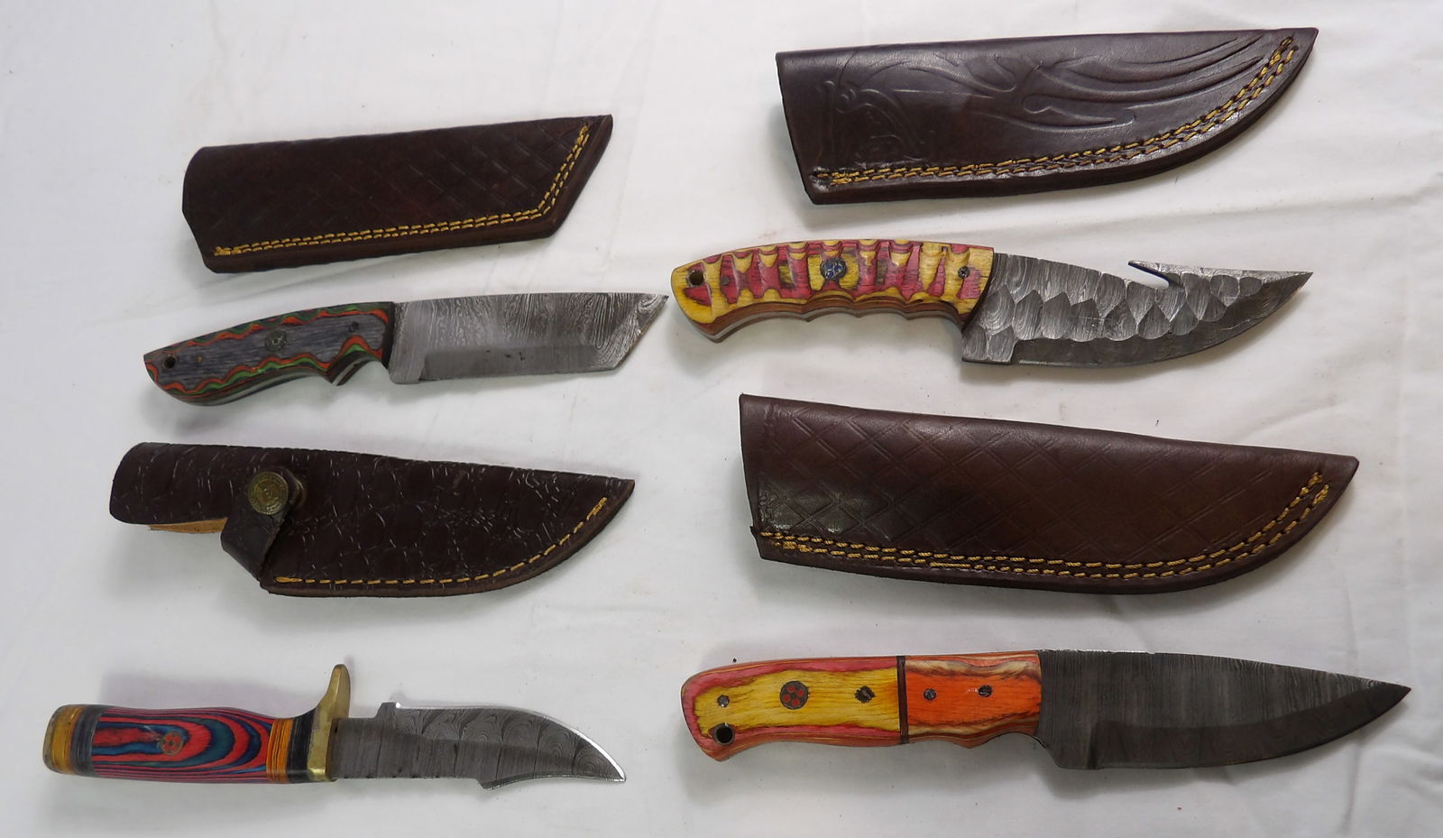 4 PCS MHS Cutlery: 4 Pieces MHS Cutlery Hand Forged Damascus Blades with Sheaths. All measurements approximate. Please see photos for condition and details. Selling as is from 04281.
