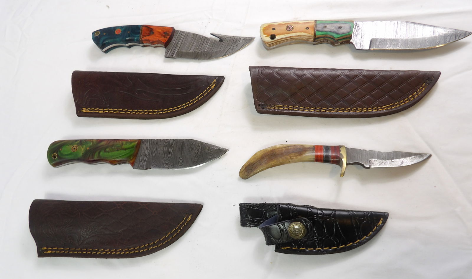 4 PCS MHS Cutlery: 4 Pieces MHS Cutlery Hand Forged Damascus Blades with Sheaths. All measurements approximate. Please see photos for condition and details. Selling as is from 04281.