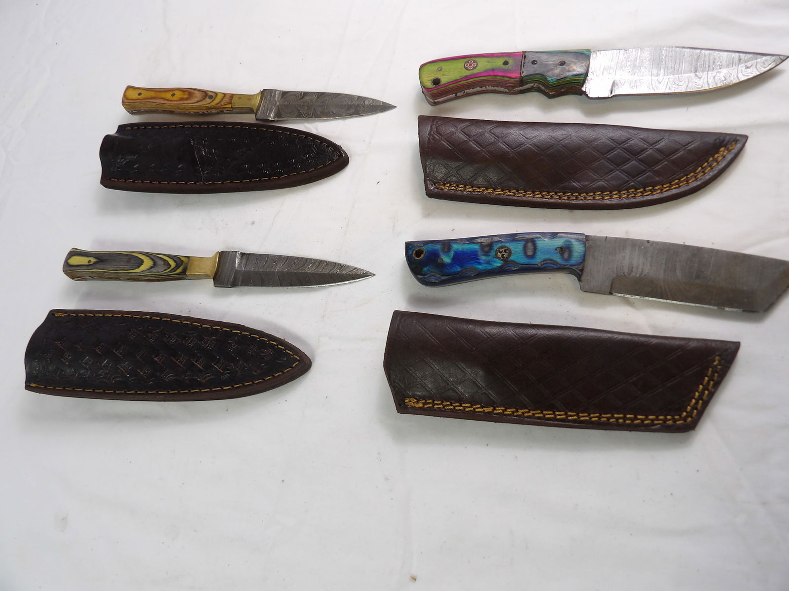 4 PCS MHS Cutlery: 4 Pieces MHS Cutlery, 2 Daggers and 2 Straight Blades, Hand Forged Damascus Steel. All measurements approximate. Please see photos for condition and details. Selling as is from 04281.