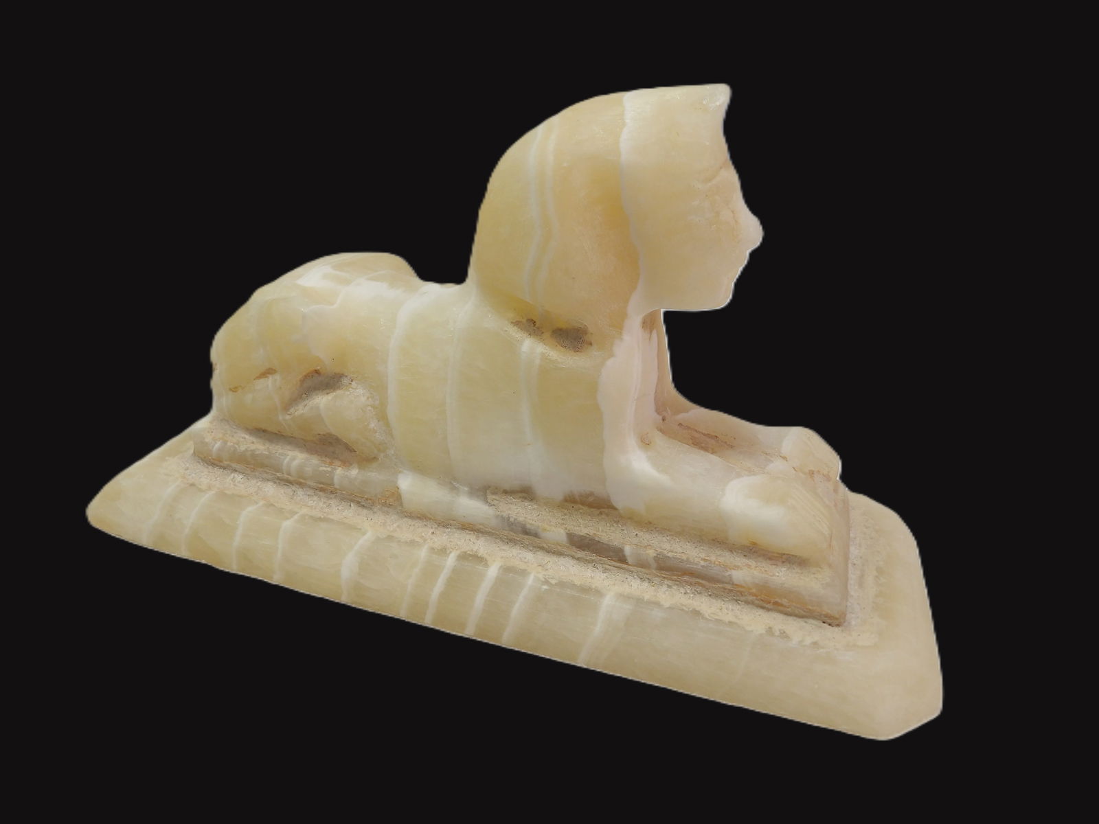 Alabaster Sphinx with Base: Carved Alabaster Sphinx with Base. Early 20th Century Egypt. All measurements approximate. Please see photos for condition and details. Selling as is from 04281.
