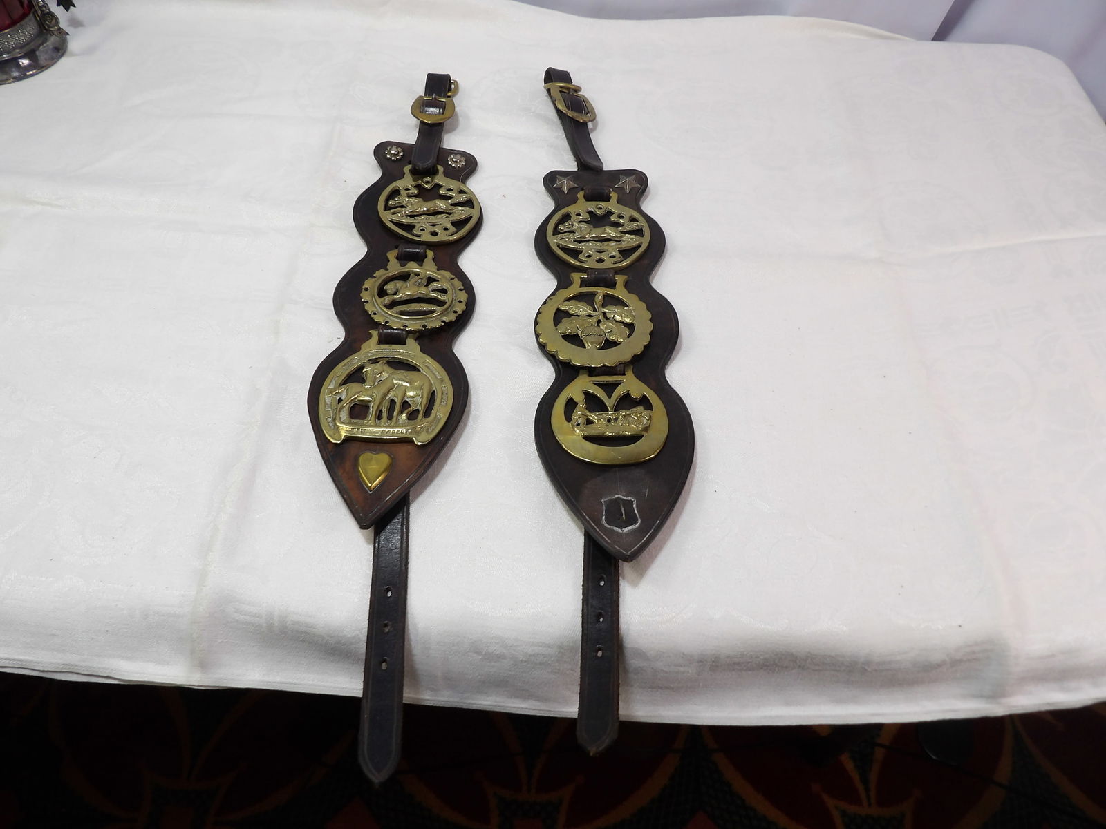 Pair of Vintage Horse Bridle Straps: Pair of Vintage Leather Horse Bridle Straps with Brass Medallions. All measurements approximate. Please see photos for condition and details. Selling as is from 04281.
