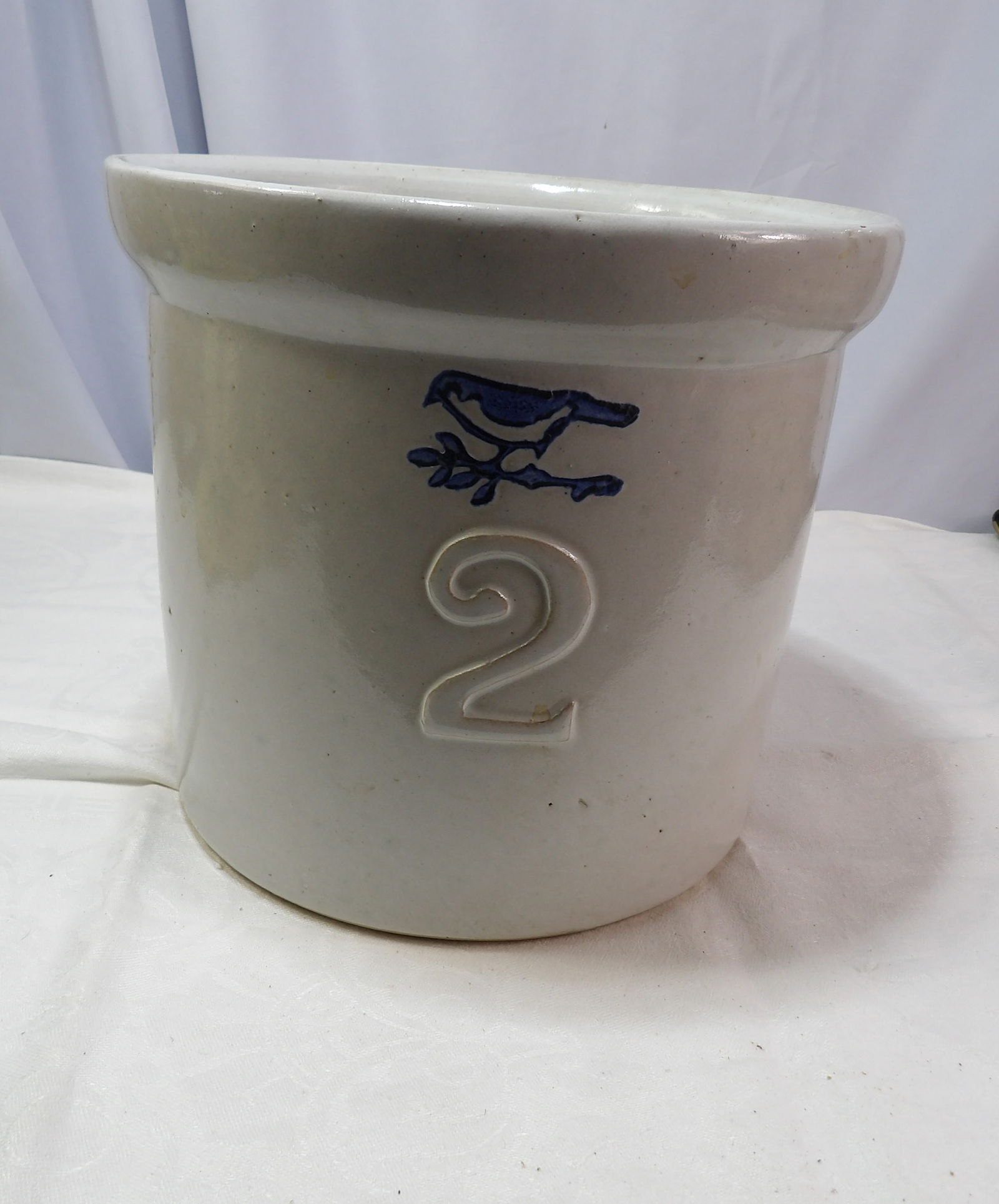 Stoneware Crock: 2 Gallon Stoneware Crock with Bird Decoration. All measurements approximate. Please see photos for condition and details. Selling as is from 04281.
