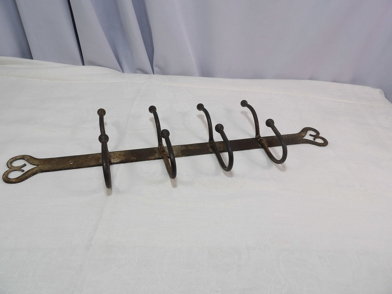 Hand Forged Iron Hanger: 24" Iron Hanger with Heart Design. Hand Forged. All measurements approximate. Please see photos for condition and details. Selling as is from 04281.