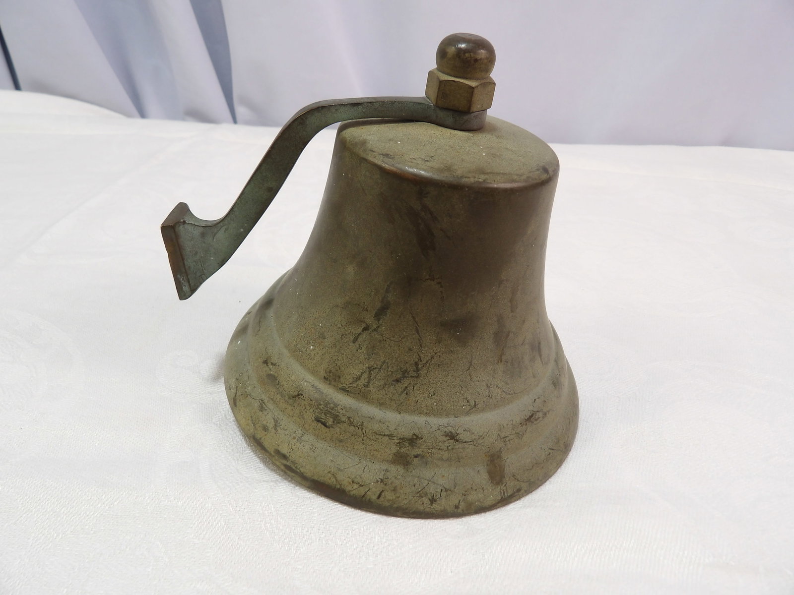 Cast Metal Bell: Antique Cast Metal Bell with Handle. 5 1/4" Diameter. All measurements approximate. Please see photos for condition and details. Selling as is from 04281.