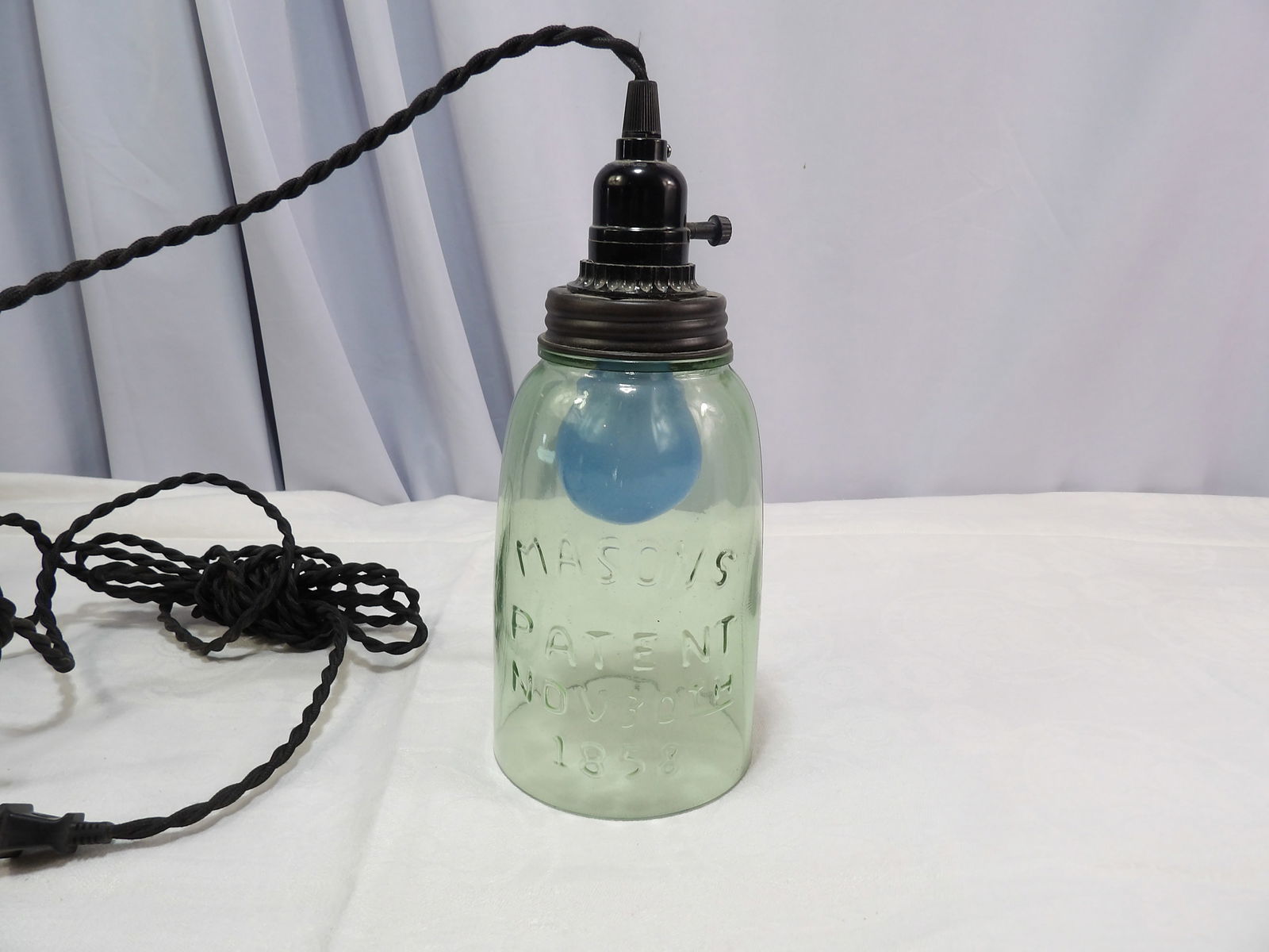 Mason Jar Lamp: Green Glass Mason Jar Lamp and Switch. Dated 1858. All measurements approximate. Please see photos for condition and details. Selling as is from 04281.