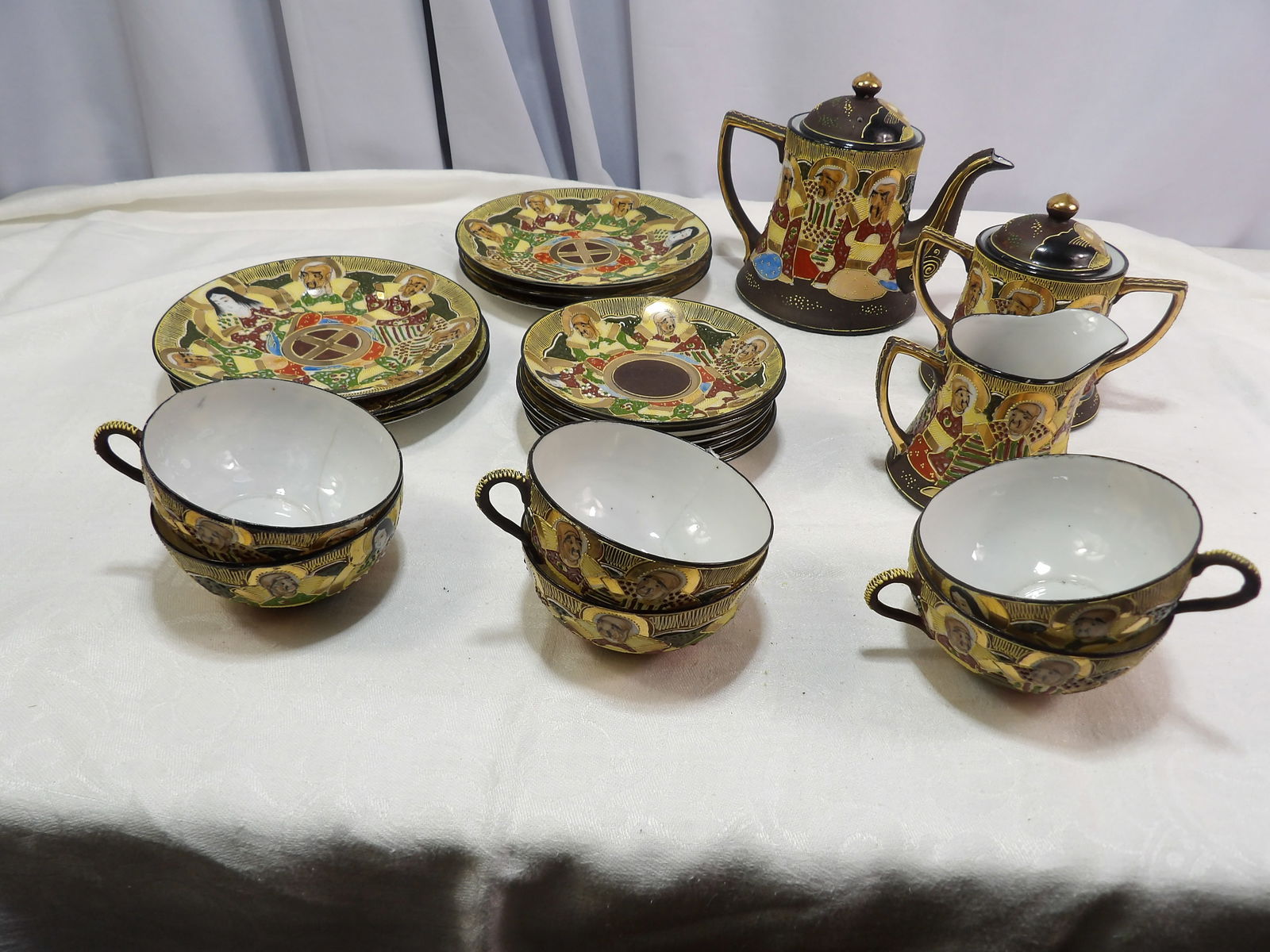 Vintage Tea Set: Vintage Japanese Satsuma Tea Set with Hand Painted Figures. All measurements approximate. Please see photos for condition and details. Selling as is from 04281.