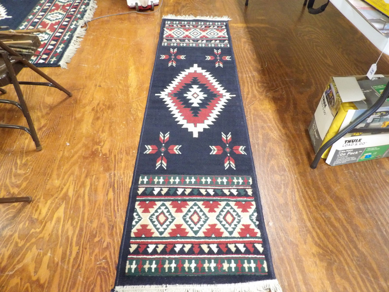 Runner Rug: Southwestern Style Runner Rug with Geometric Patterns. 2' x 7'. All measurements approximate. Please see photos for condition and details. Selling as is from 04281.