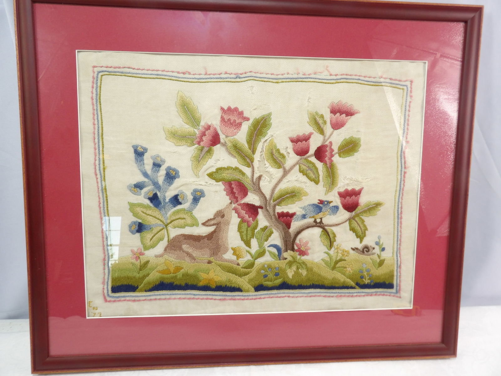 Framed Crewelwork: 18" X 21" Frame Crewelwork Embroidery with Deer and Floral Motif. All measurements approximate. Please see photos for condition and details. Selling as is from 04281.