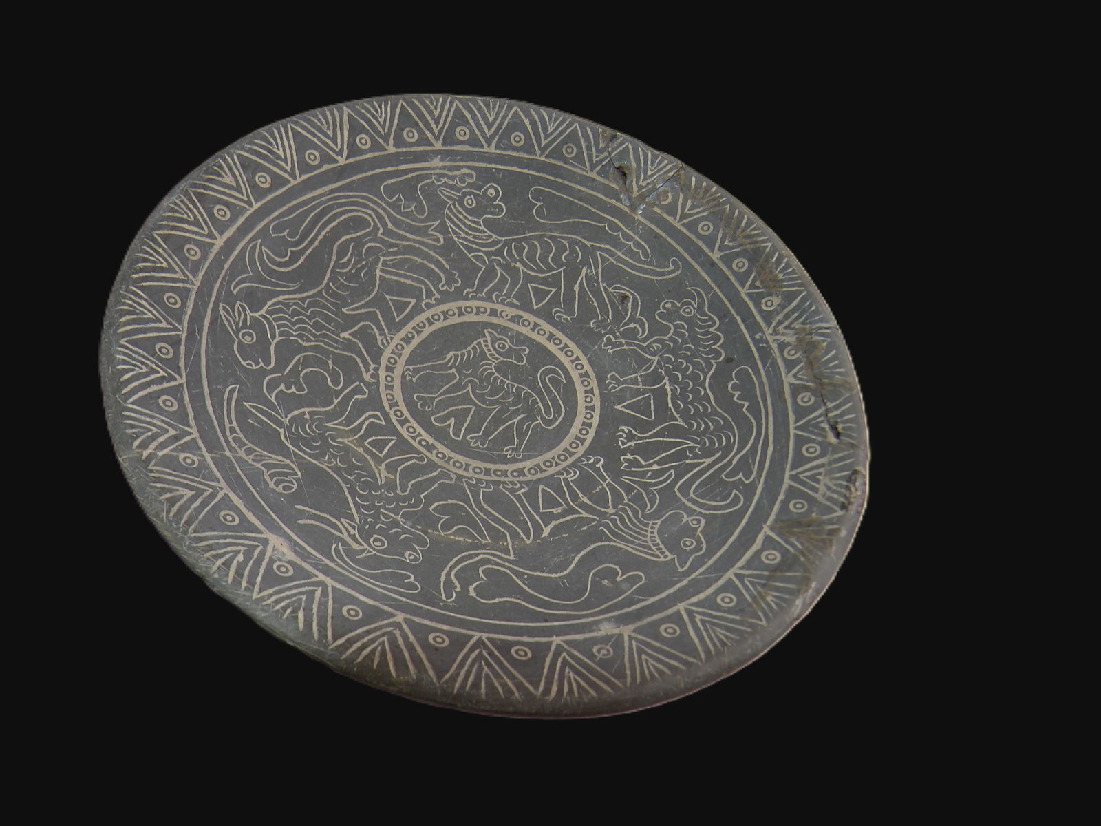 Round Stone Disc: Archaic Style Round Stone Disc with Mythological Animal Motifs. Likely East Asia. All measurements approximate. Please see photos for condition and details. Selling as is from 04281.