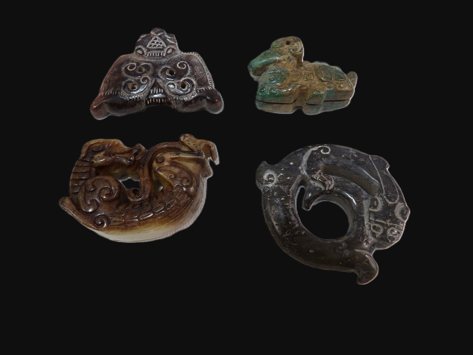4 PCS Chinese Amulets: Four Chinese Carved Jade Amulets. All measurements approximate. Please see photos for condition and details. Selling as is from 04281.
