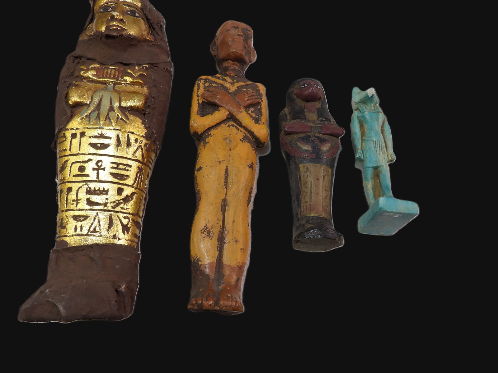 4 PCS Early Figurines: 3 Shabti Figures and 1 Anubis Figure. Likely 1900's. All measurements approximate. Please see photos for condition and details. Selling as is from 04281.