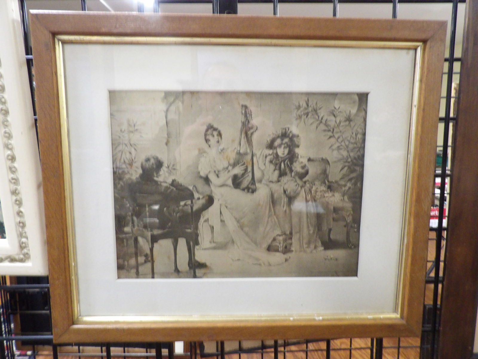 Framed Lithograph: Framed 19th Century Lithograph. "La Romance", Woman Playing Harp. 16" X 19". All measurements approximate. Please see photos for condition and details. Selling as is from 04281.