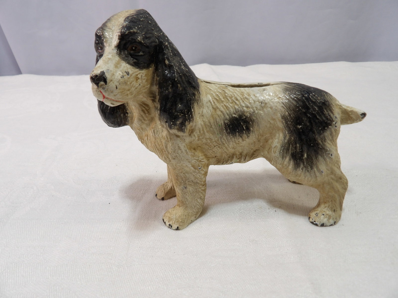 Cast Iron Bank: Cast Iron Black and White Spaniel Dog Bank. 5" Tall X 7" Long. All measurements approximate. Please see photos for condition and details. Selling as is from 04281.