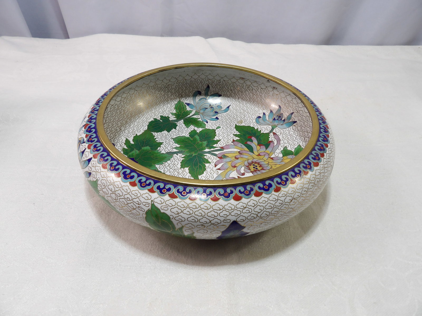 Vintage Chinese Cloisonne Bowl: Vintage Chinese Cloisonne Bowl with Floral Design. 10" Diameter. All measurements approximate. Please see photos for condition and details. Selling as is from 04281.