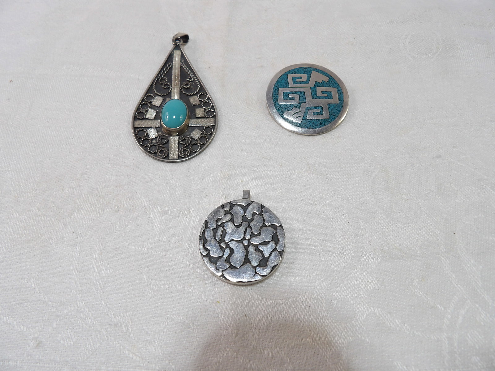3 PCS-Sterling Silver Pendants: 3 Pieces Native American Sterling Silver Pendants, 38 Grams. All measurements approximate. Please see photos for condition and details. Selling as is from 04281.
