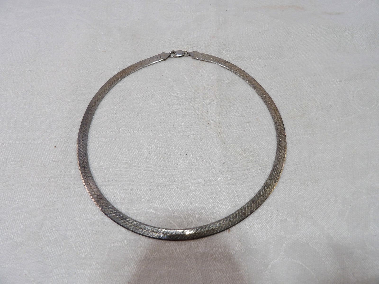 Vintage Sterling Silver Necklace: Vintage Herringbone Sterling Silver Necklace, 20 Grams. All measurements approximate. Please see photos for condition and details. Selling as is from 04281.