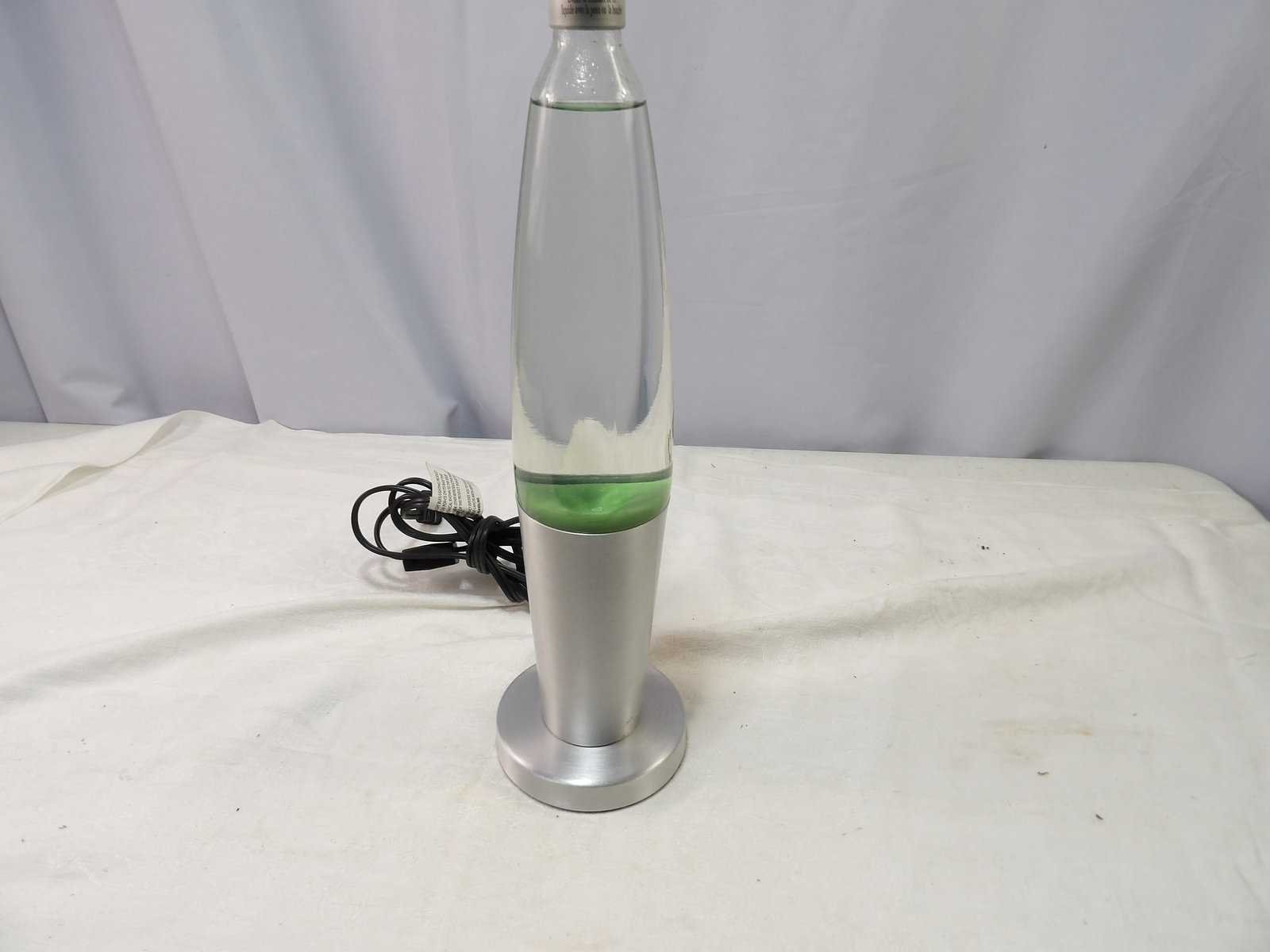 Green Lava Lamp: Green Lava Lamp with silver base. All measurements approximate. Please see photos for condition and details. Selling as is from 04281.