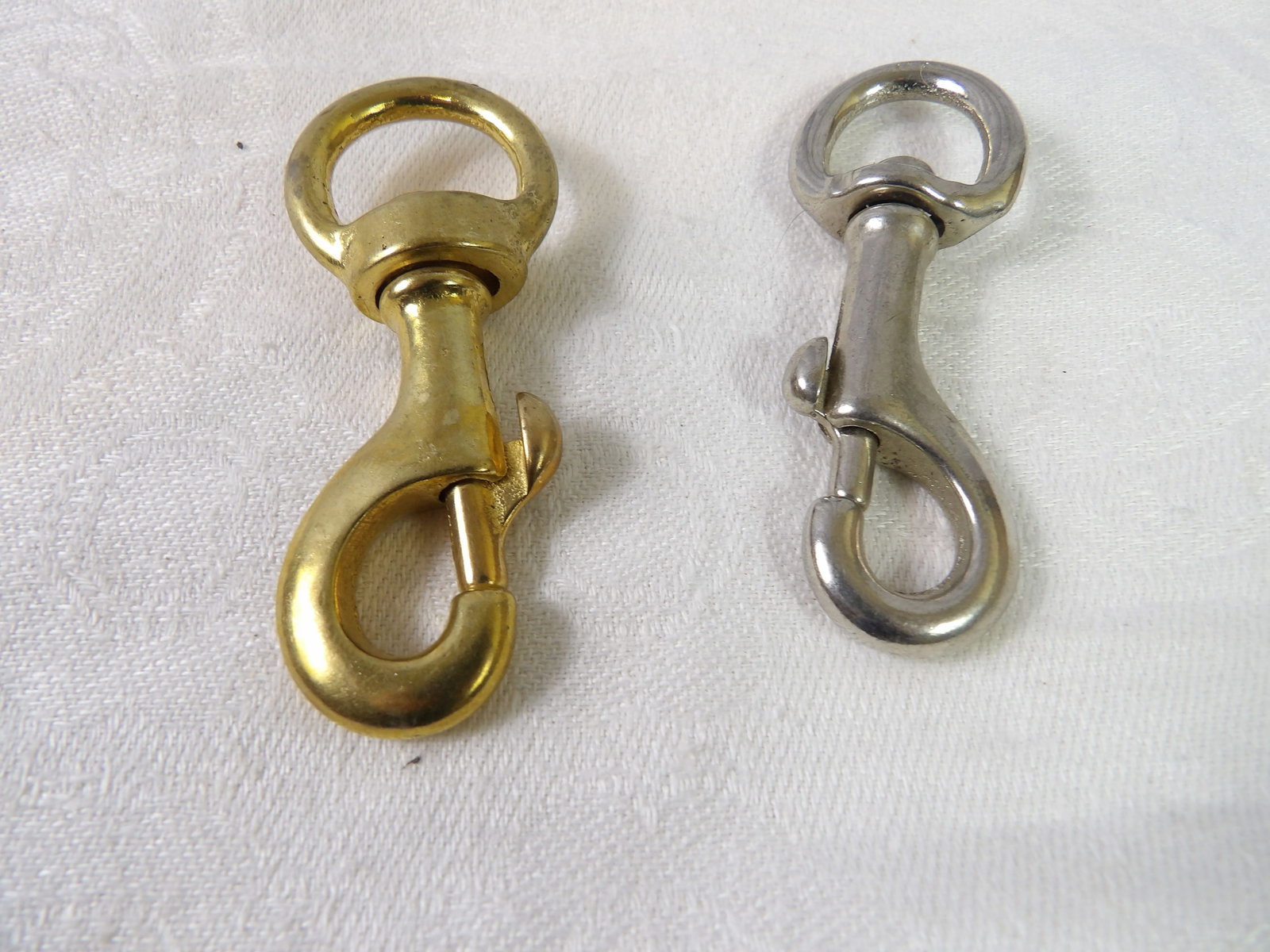 Large Collection of New Swivel Snap Hooks: Large Collection of "New" Swivel Snap Hooks, Brass and Steel. All measurements approximate. Please see photos for condition and details. Selling as is from 04281.
