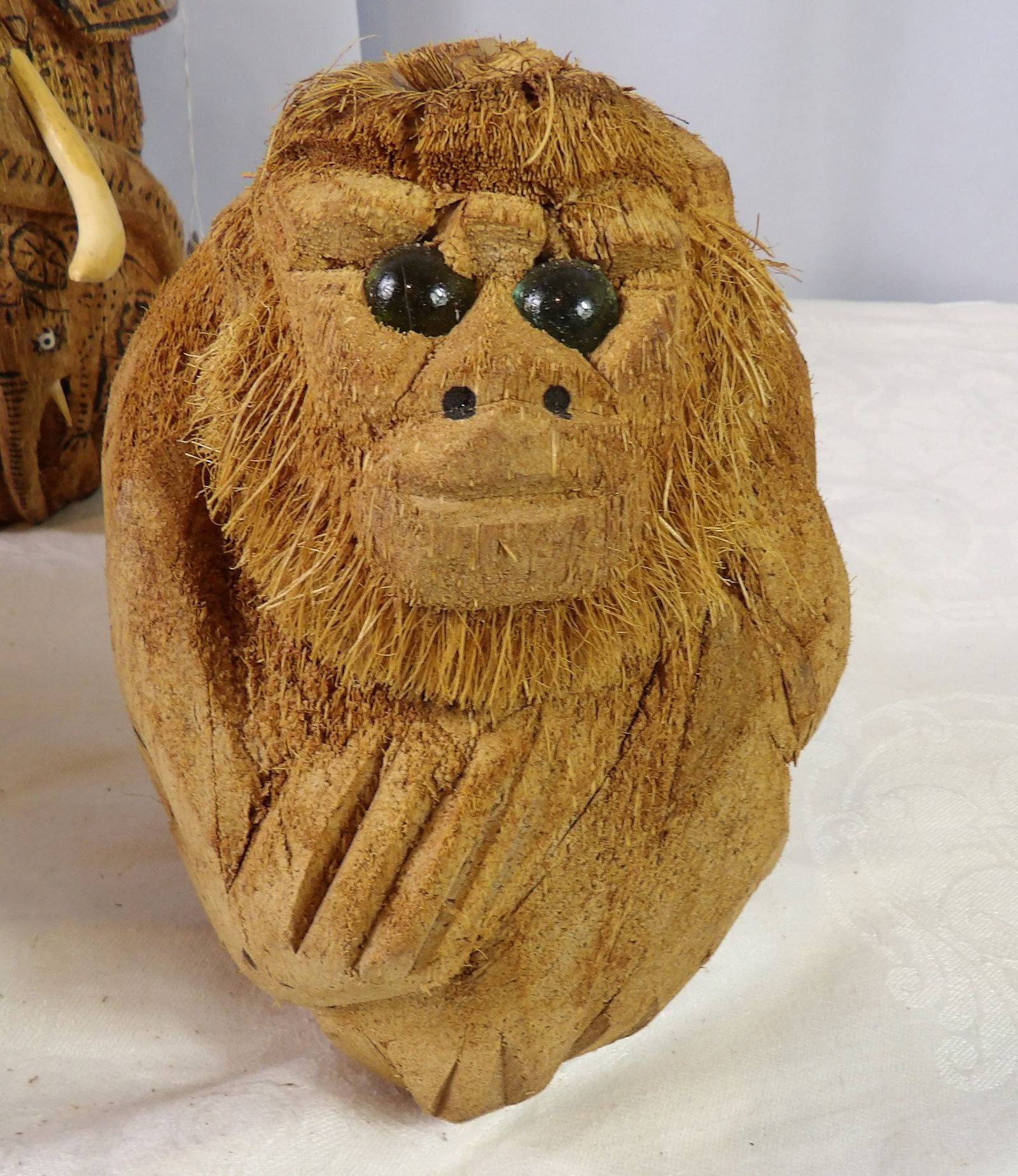 Hand Carved Coconut Monkey: Sri Lankan Hand Carved Coconut Monkey with Glass Eyes. All measurements approximate. Please see photos for condition and details. Selling as is from 04281.
